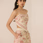 Woman wearing a floral two-piece outfit against a plain background Calling June
