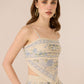Woman wearing a floral dress with a beige background Calling June