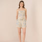 Woman wearing a floral dress on a beige background Calling June