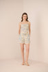Woman wearing a floral dress on a beige background Calling June