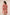 Woman wearing a pink dress with white patterns on a plain background Calling June