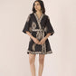 Woman wearing a black and white patterned dress on a beige background Calling June