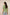 Woman wearing a green top with floral embroidery on a beige background Calling June