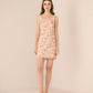 Woman wearing a floral dress against a plain background Calling June