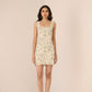 Woman wearing a floral dress against a plain background Calling June