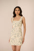 Woman wearing a floral dress against a plain background Calling June
