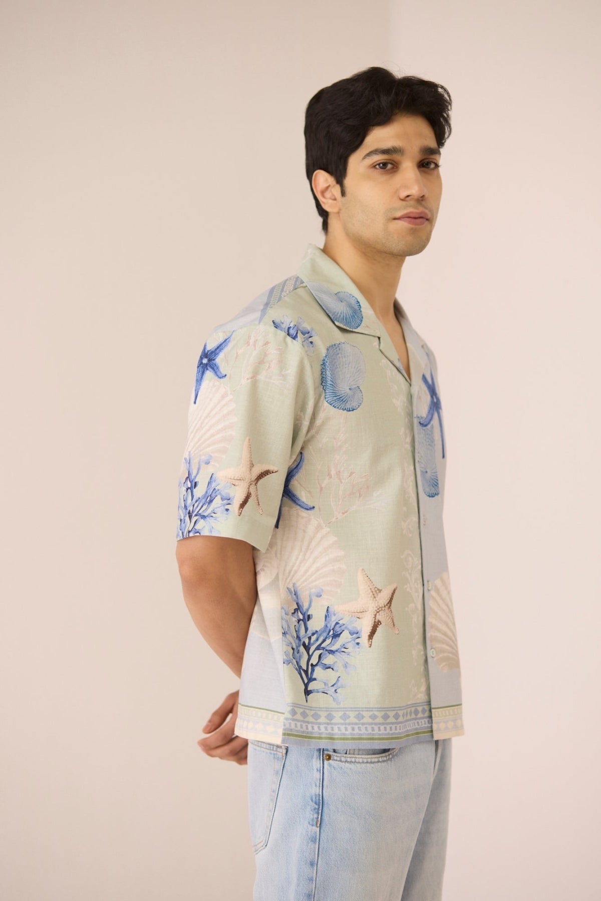 Man wearing a patterned shirt with a neutral background Calling June