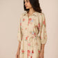 Woman wearing a floral dress with a beige background Calling June