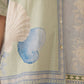 Light green fabric with blue shell design and intricate patterns Calling June