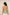 Woman wearing a green halter top with a beige background Calling June