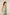 Woman wearing a light green sleeveless top and shorts set on a beige background Calling June