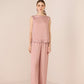 Woman wearing a pink textured sleeveless top and pants on a beige background Calling June